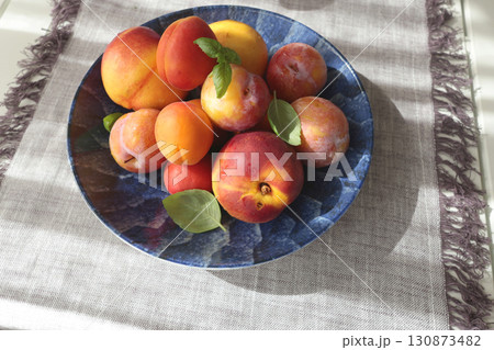 Fruits on porcelain plate with blue pattern. Food and vitamins, healthy eating. Seasonal food. 130873482