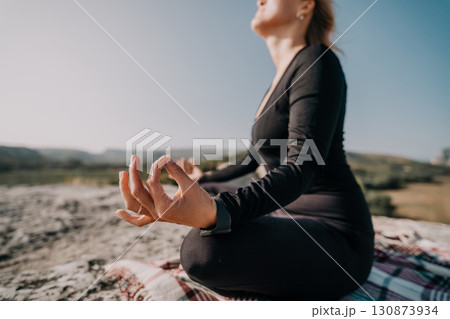 Woman Meditating in the Mountains Woman Meditating in the Mountains 130873934