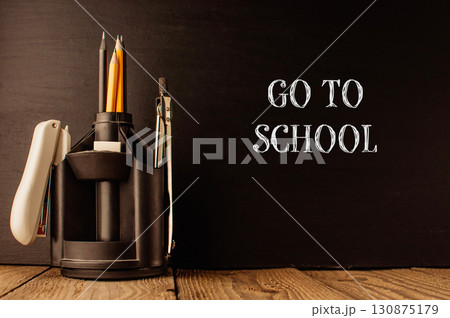 Black desk with a pencil holder and a pencil sharpener 130875179