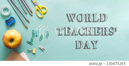 A green background with a bunch of school supplies 130875265