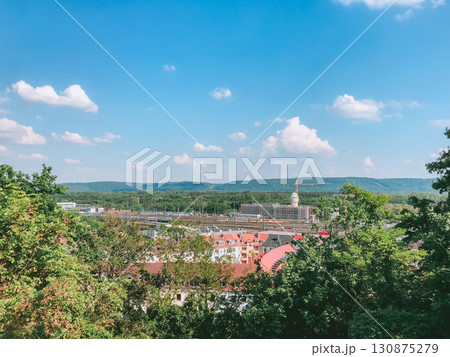 Beautiful view of a city with a red roof and a tall building in the distance Beautiful view of a city with a red roof and a tall building in the distance 130875279