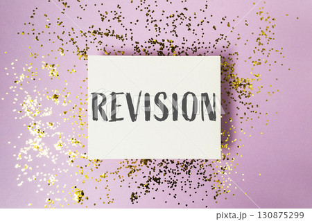 Revision is a word written on a white background with gold glitter Revision is a word written on a white background with gold glitter 130875299