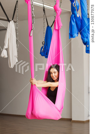 Yoga position in hammock with stretched arms Yoga position in hammock with stretched arms 130877078
