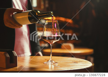 Glass Being Filled with Red Wine at Wine Bar 130877228