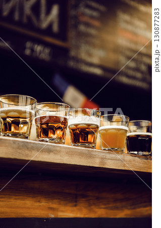 Various Tasting Beers Arranged on Bar Counter Showcasing Different Colors and Sort Styles 130877283