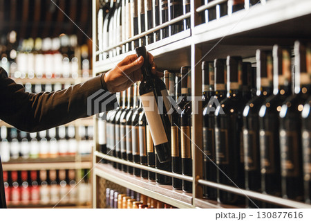 Cavist Selecting Fine Bottle From Extensive Wine Cellar Collection 130877616