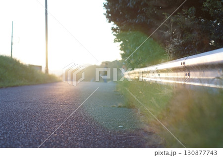 夕日とガードレール 130877743
