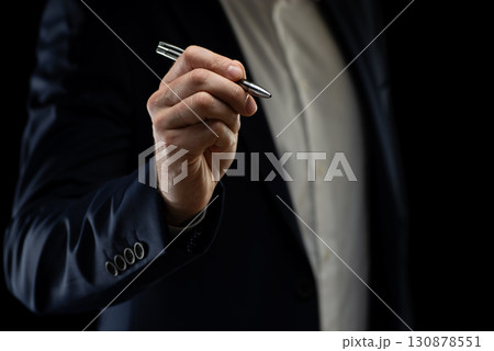 Businessman with pen in hand. High quality photo 130878551