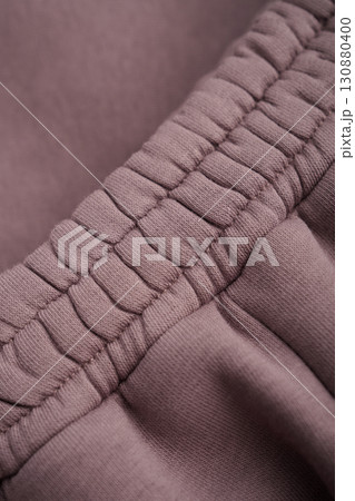Warm mocha tracksuit. Close-up of elastic waistband. Cotton. Warm mocha tracksuit. Close-up of elastic waistband. Cotton. 130880400