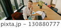 A Professional Woman Engaged in Tasks at Her Work in a Modern and Stylish Office Setting 130880777