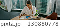 A Professional Woman Engaged in Active Work in a Contemporary Office Environment 130880778