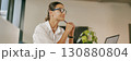 A Professional Woman Sitting in the Office Deep in Thought Within a Contemporary Workspace 130880804