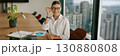 A Business Professional engaging in productive activities within a contemporary meeting space 130880808