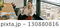 A dedicated businesswoman collaborating effectively with colleagues in a modern office 130880816