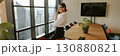 A professional woman is in her office making a crucial business call that may affect her career 130880821