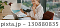A confident businesswoman is analyzing growth data meticulously in a modern office space 130880835
