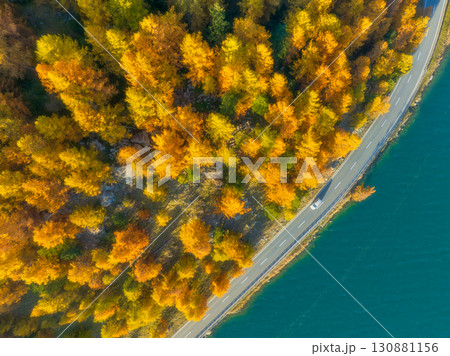 Winding road along the lake. Road near the forest. Drone view of a road with cars. Winding road along the lake. Road near the forest. Drone view of a road with cars. 130881156