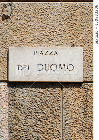 marble sign marks Piazza del Duomo in Milan 130883206