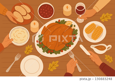 Family dinner table with Thanksgiving turkey, side dishes and candles in warm autumn colors 130883248