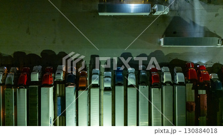 a row of vehicles, possibly buses or trucks, parked closely together a row of vehicles, possibly buses or trucks, parked closely together 130884018