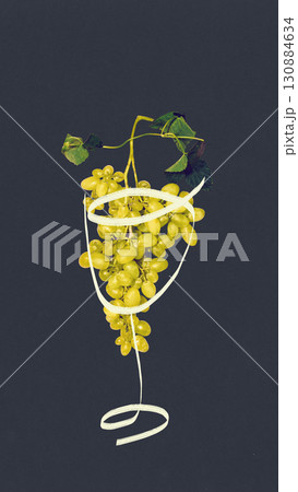 Modern collage. Green grape bunch inside outlined wineglass on dark background 130884634