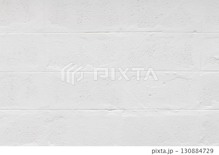 Clean white brick wall texture provides simple background. rough material on exterior of house shows minimalist pattern great for interior design and has calm feeling 130884729