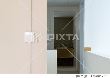 Calm interior detail of modern house renovation showing minimalist hallway and architectural construction. serene view of new building project design progress 130884762