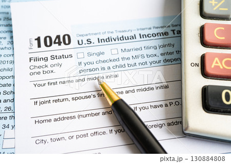 Tax Return form Individual Income with calculator and pen. Tax Return form Individual Income with calculator and pen. 130884808