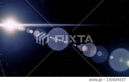 Abstract lens flare overlay with white light on dark background, vintage optical effect with blue bokeh for cinematic video editing and photo montage 130884837