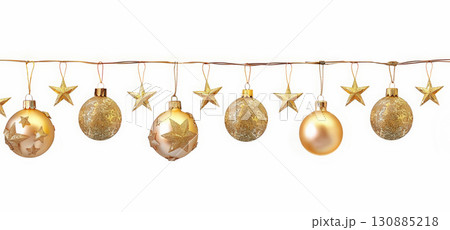 Gold Christmas ornaments and stars hanging on wire 130885218