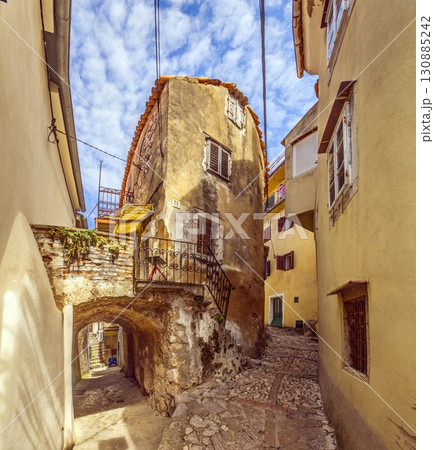Narrow cobbled alley in old Vrbnik Croatia 130885242