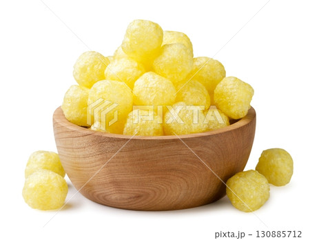 Corn balls in a wooden plate on a white background. Isolated 130885712