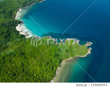 Rocky beach with ocean waves and turquoise sea water. El Nido, Palawan. Philippines. 130886954
