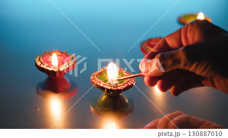 Radiant Diwali candles illuminating dark night Radiant Diwali candles illuminating dark night 130887010