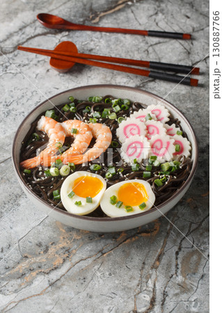 Soba buckwheat noodles with shrimp, kamaboko, green onion and egg close-up in a bowl. Vertical Soba buckwheat noodles with shrimp, kamaboko, green onion and egg close-up in a bowl. Vertical 130887766