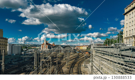 Railway station with multiple train tracks under a dramatic sky filled with clouds 130888533