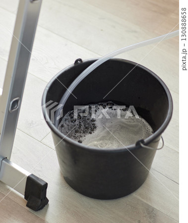 Step ladder and bucket with water, top view. cleaning concept Step ladder and bucket with water, top view. cleaning concept 130888658