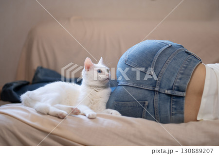 白い猫と女性のお尻 130889207
