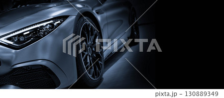 Front view of LED headlights sport car on black background is color blue tone  130889349