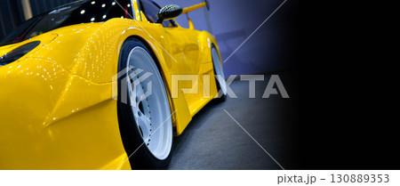 Front headlights of yellow modify car on black background, copy space Front headlights of yellow modify car on black background, copy space 130889353