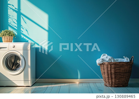 Bright blue wall enhances this laundry room featuring a washing machine and a wicker basket filled with clothes. 130889465