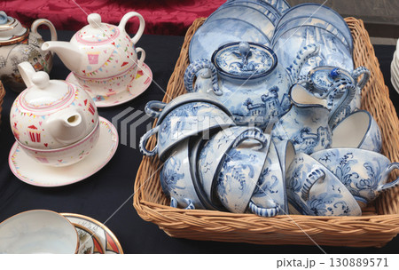 Chiaveri, Italy - September 13, 2025. Flea antique market in Europe, Italy. Old vintage items. Dishes on table in town. Retro objects for design. Chiaveri, Italy - September 13, 2025. Flea antique market in Europe, Italy. Old vintage items. Dishes on table in town. Retro objects for design. 130889571