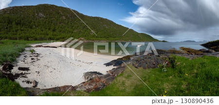 White Sand Beach With Red Cottage And Calm Fjord On Sommaroy Island In Norway White Sand Beach With Red Cottage And Calm Fjord On Sommaroy Island In Norway 130890436