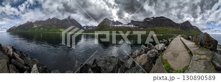 Calm Fjord With Red Huts In Front Of Snowy Mountains On Senja Island In Norway 130890589