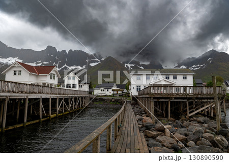 Cottages, Wooden Pier And Snowy Mountains In Mefjordvaer On Senja Island In Norway Cottages, Wooden Pier And Snowy Mountains In Mefjordvaer On Senja Island In Norway 130890590