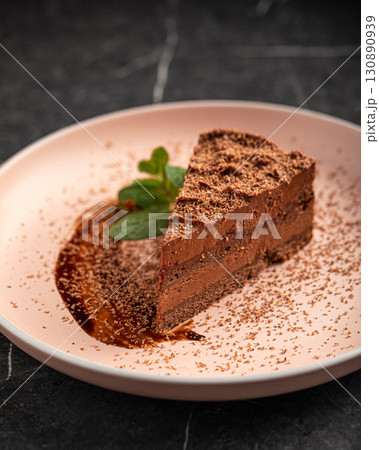 Delicious chocolate cake with mint and sauce Delicious chocolate cake with mint and sauce 130890939