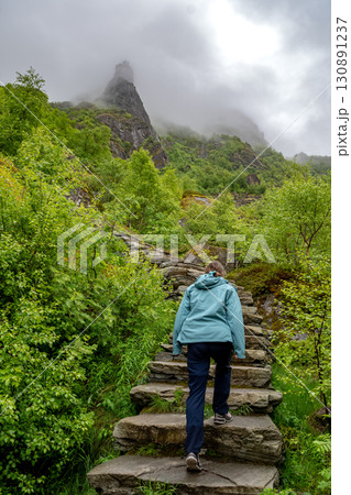 Woman Hiking On Devils Stairs To Djevelporten The Devils Stone In Svolvaer On Lofoten Islands In Norway 130891237