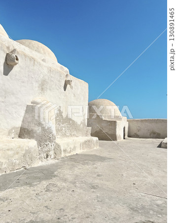 Historic architecture of Sidi Yeti Mosque in Guellala, Djerba with a clear blue sky 130891465
