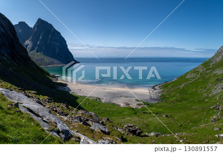 Kvalvika Sand Beach With Mountains And Ocean On Lofoten Islands In Norway Kvalvika Sand Beach With Mountains And Ocean On Lofoten Islands In Norway 130891557