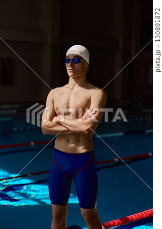 Swimmer standing with arms crossed showing confidence Swimmer standing with arms crossed showing confidence 130891872